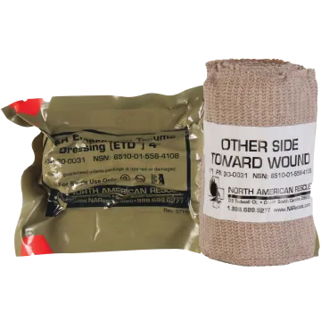 North American Rescue Emergency Trauma Dressing ETD showing vacuum sealed OD green package alongside unrolled tan elastic bandage with Other Side Toward Wound label and NAR branding