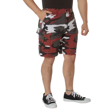 Man wearing red camo BDU cargo shorts, angled front view showing cargo pockets and red camouflage pattern